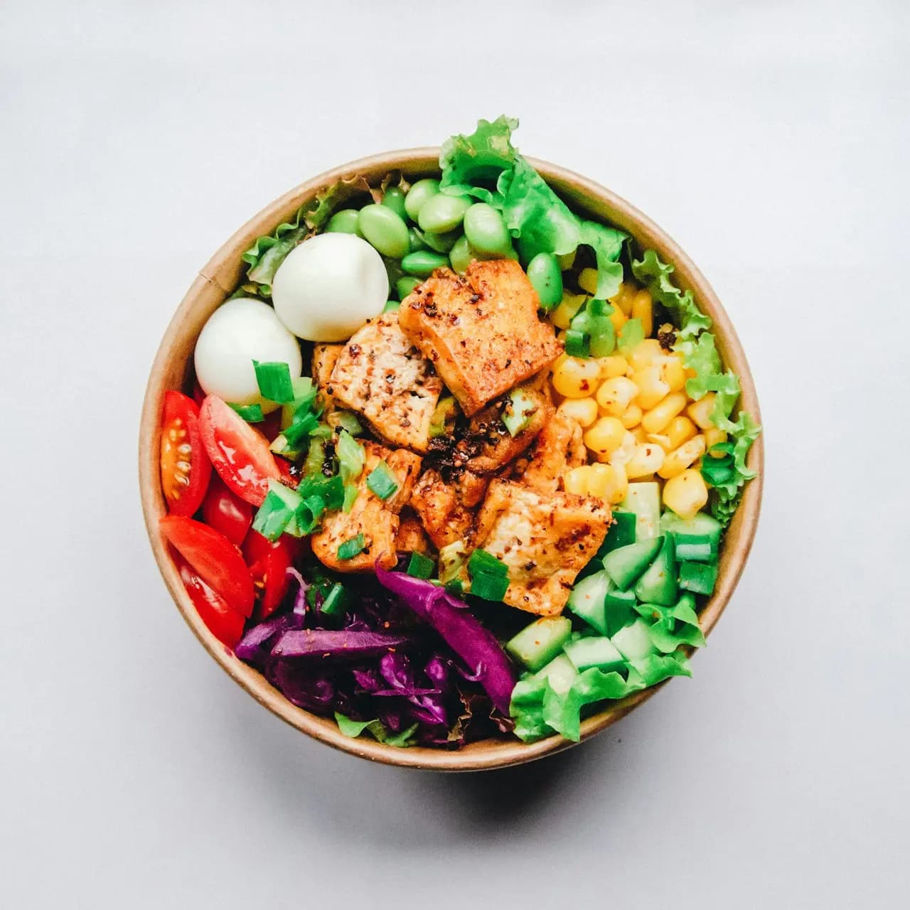Overhead shot of a bowl filled with colourful vegetables prepared for children’s healthy eating program.
