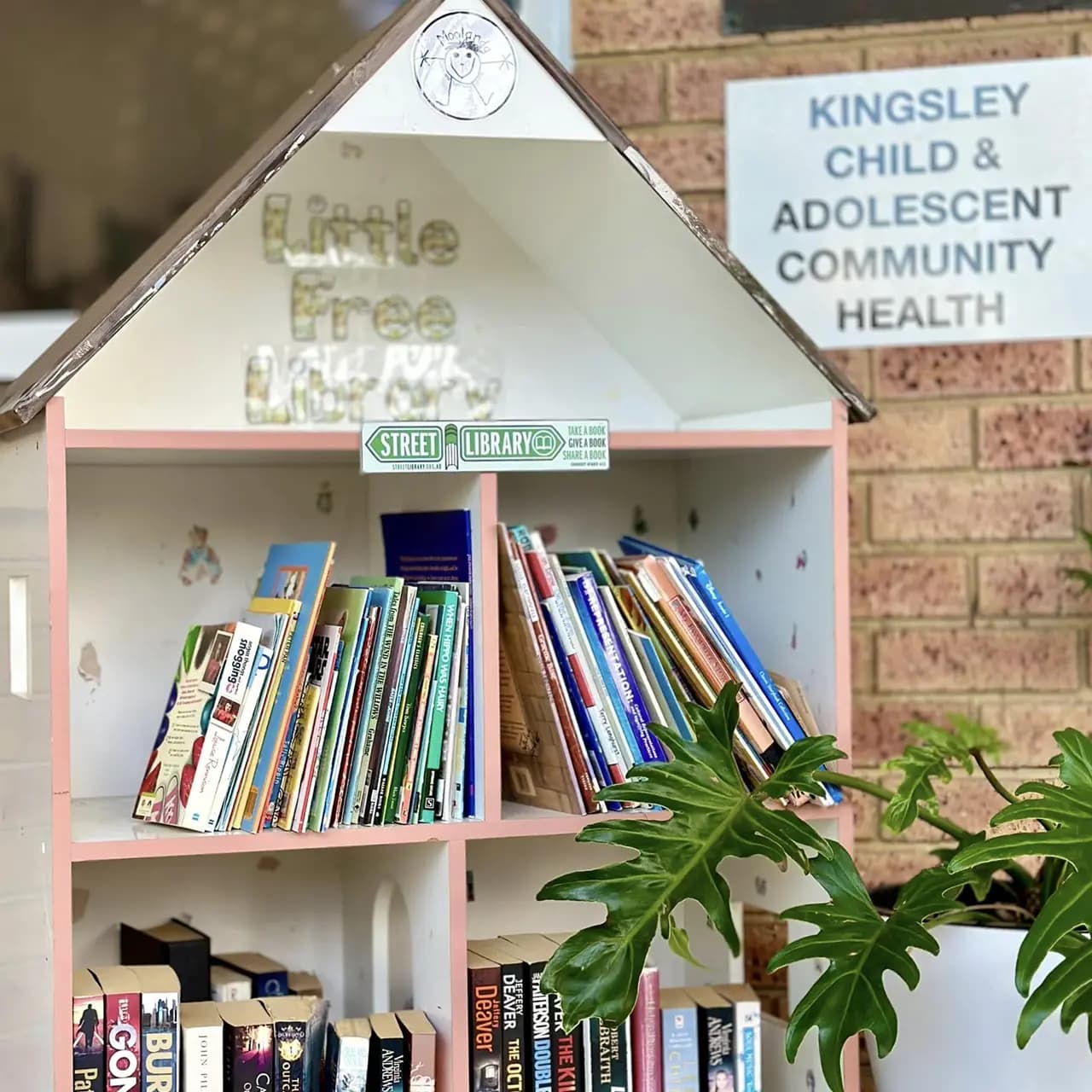 Furniture shaped like miniature houses filled with multiple books, encouraging early literacy and exploration.